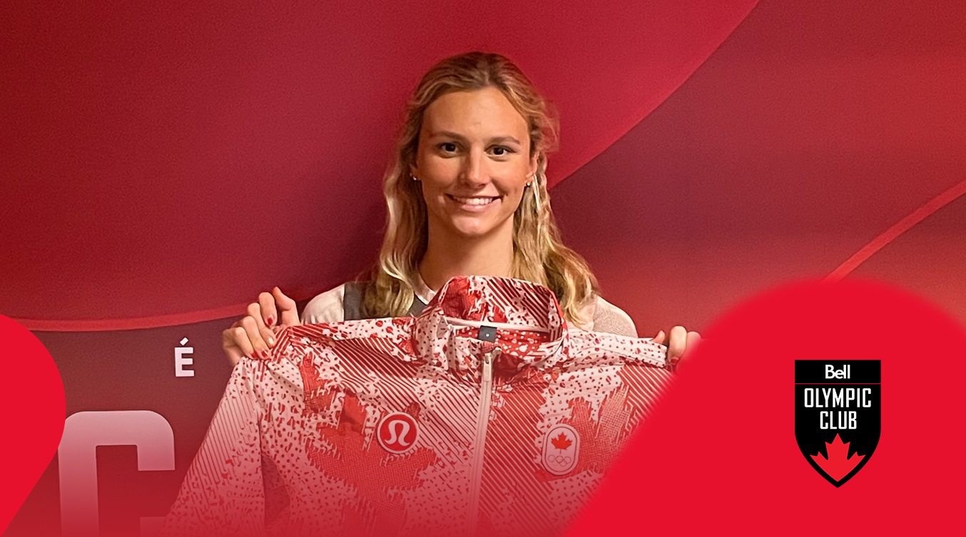 Athlete holding a signed Team Canada jacket