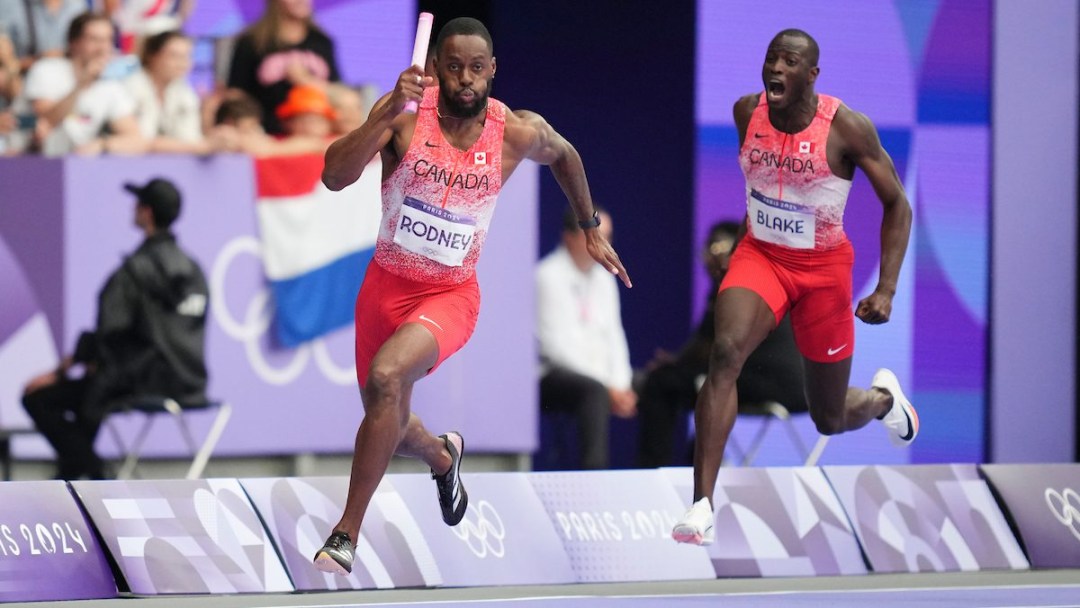 Jerome Blake yells after handing the baton to Brendon Rodney