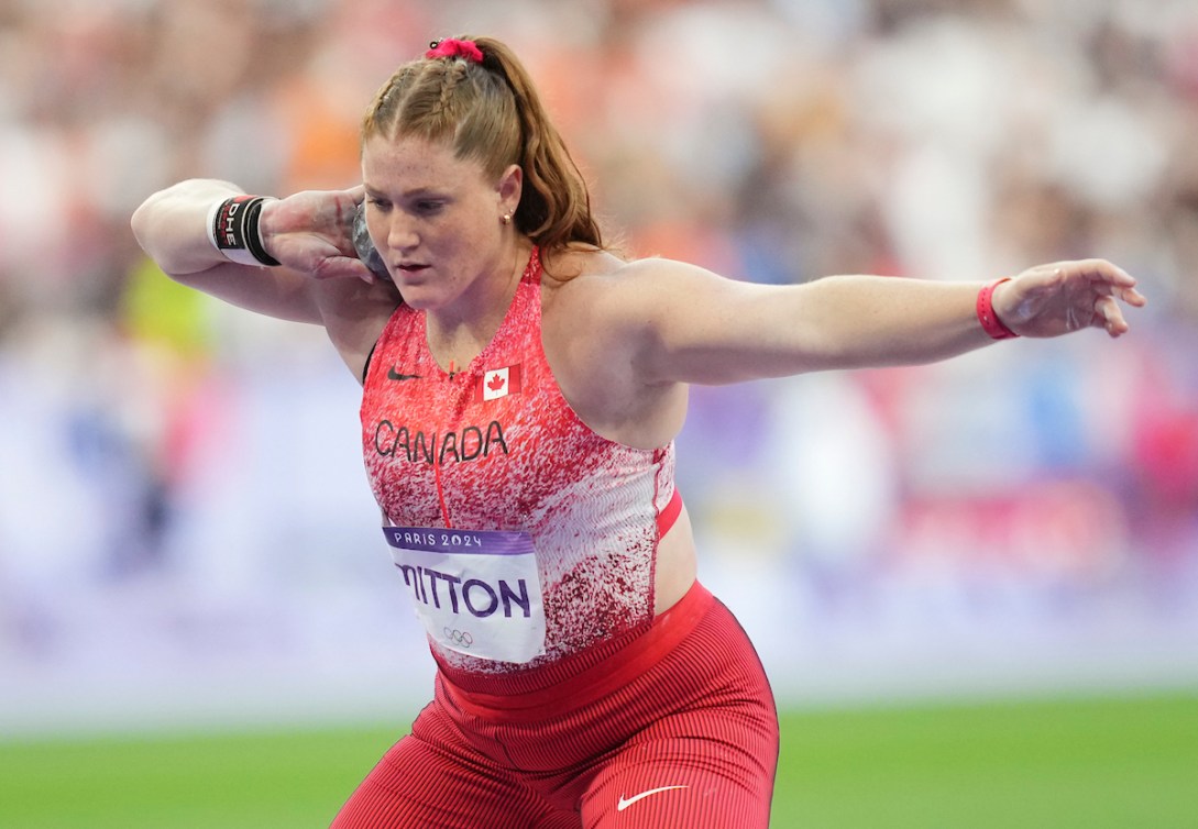 Sarah Mitton prepares to throw a shot put 