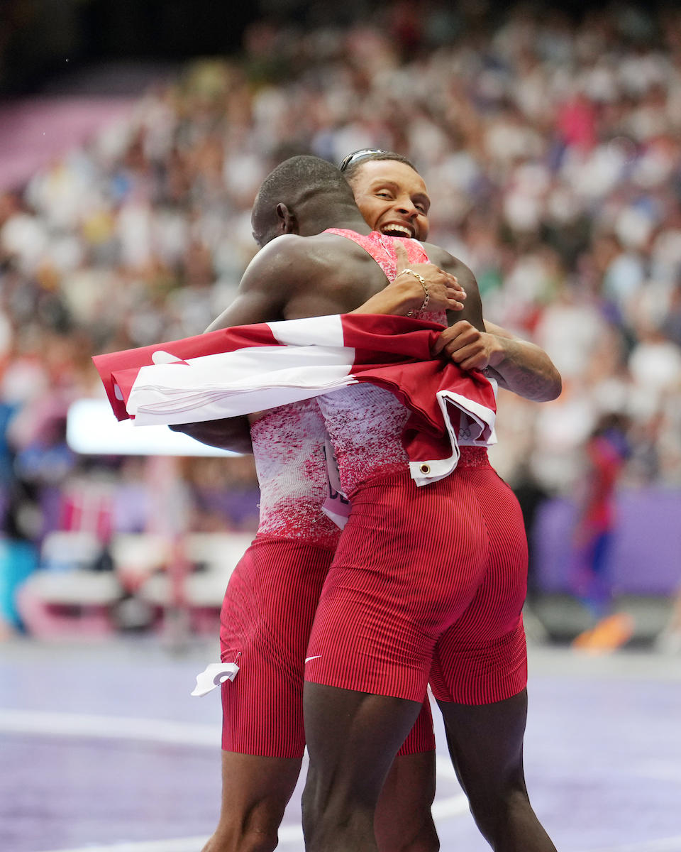 Andre De Grasse and Jerome Blake hug in celebration