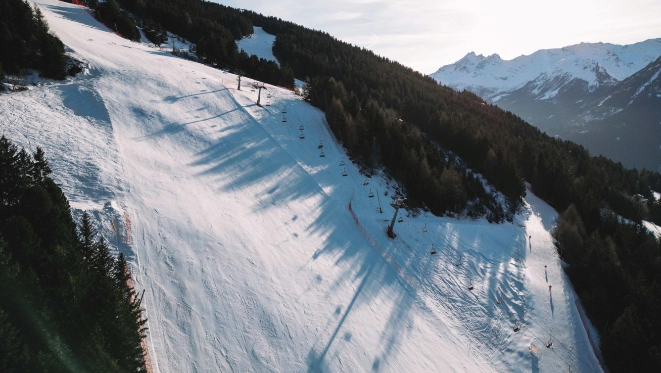 An aerial shot of the Stelvio slope, with a chairlift going up