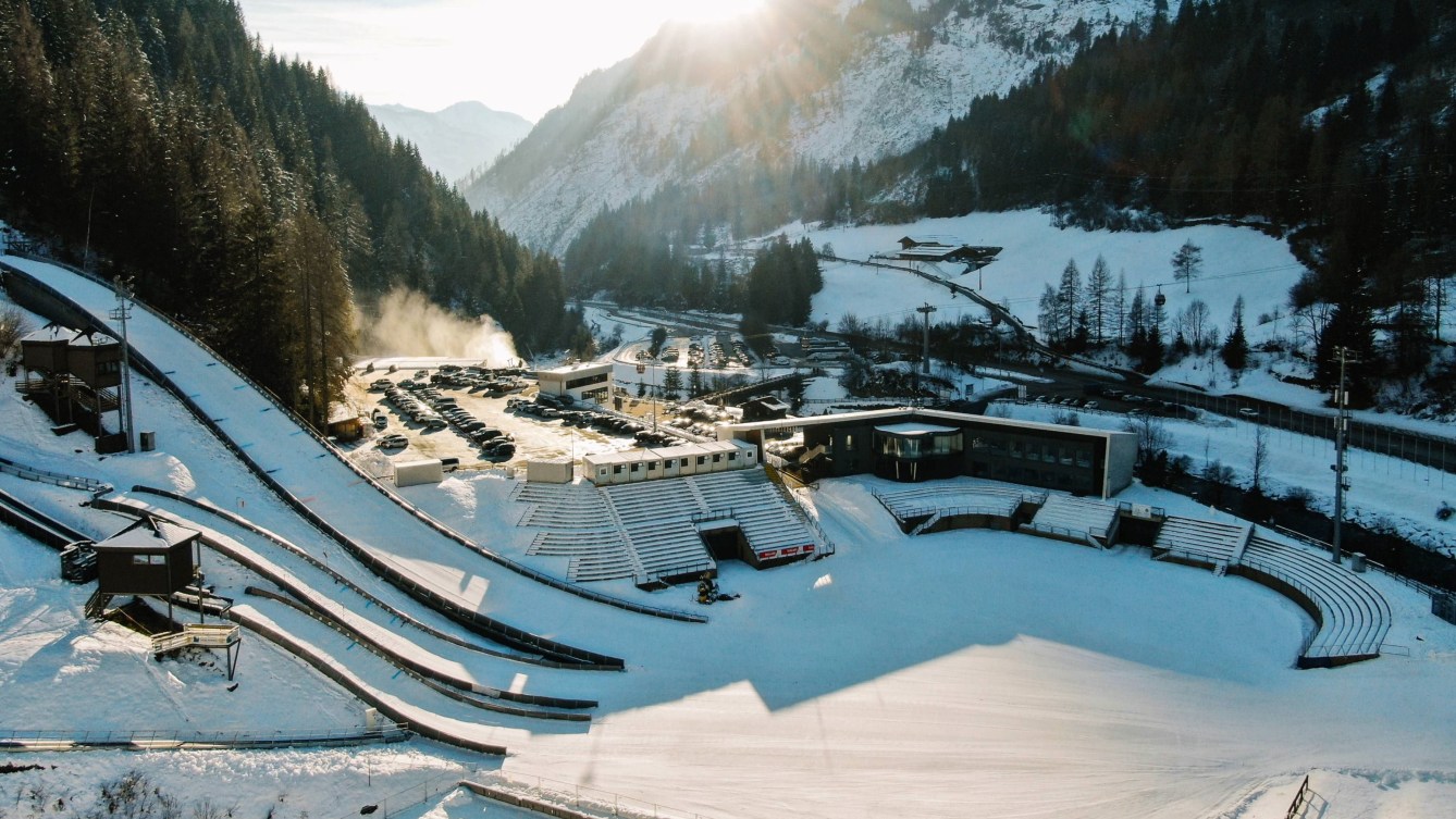 An overhead shot of a ski jumping facility with stands