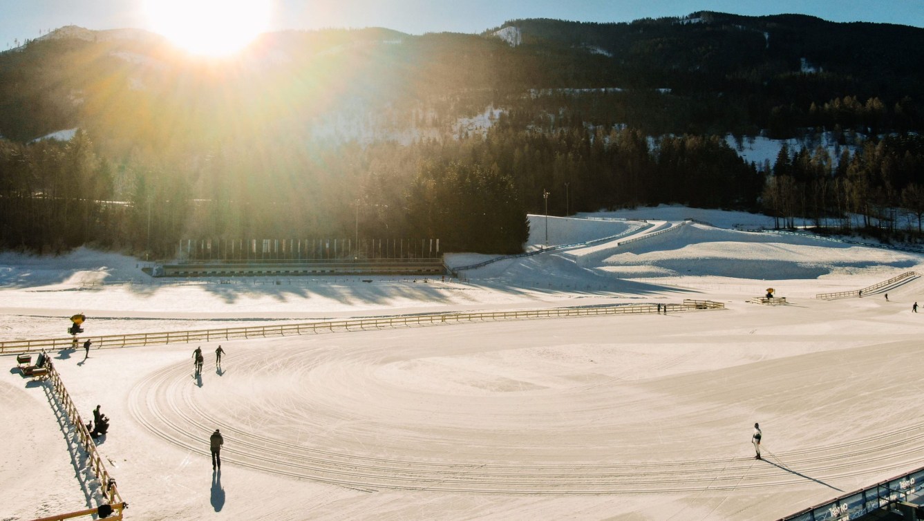 Shot of a cross-country ski area with athletes skiing around a track