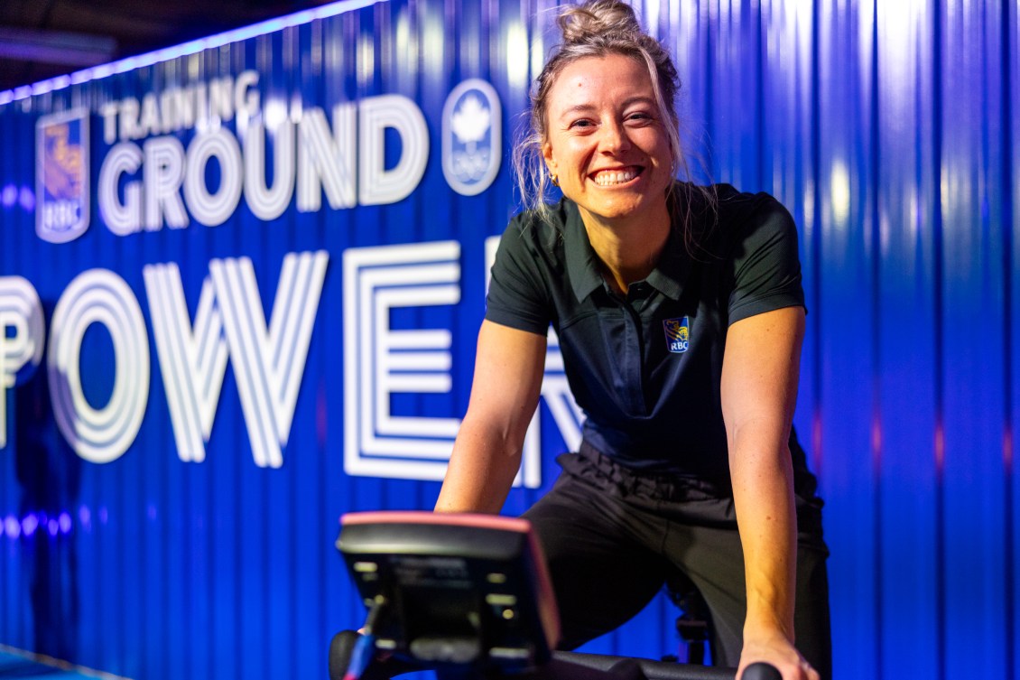 Kelsey Mitchell smiles while sitting on a spin bike at the RBC Training Ground National Final