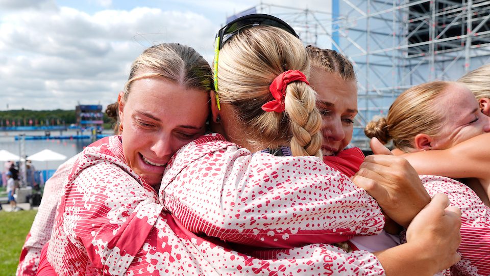 Members of Team Canada's women's eight hug each other