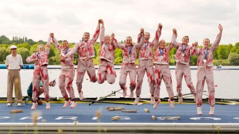 The Team Canada women's eight jumps in the air on the podium at Paris 2024