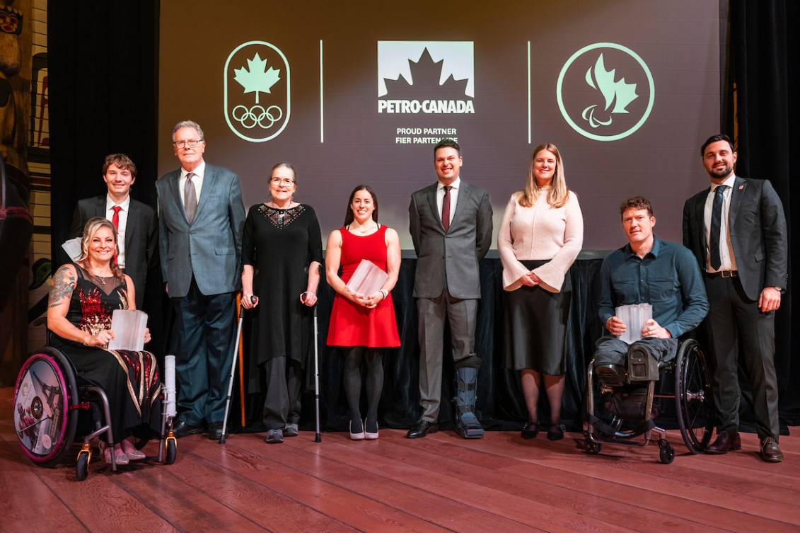 Olympians and Paralympians pose in front of a black backdrop with Petro Canada logo 