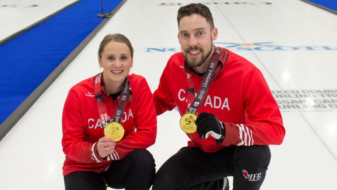 Jocelyn Peterman and Brett Gallant wear red Canada jackets and gold medals around their necks