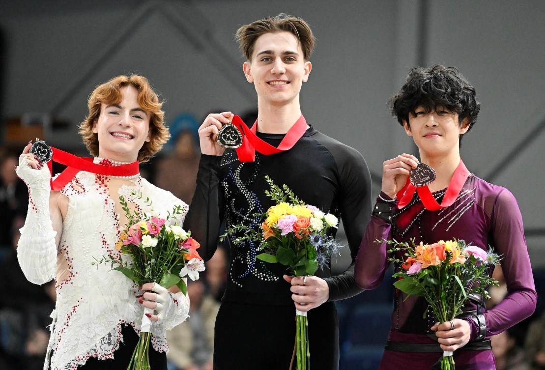 Gold medalist Roman Sadovsky, centre, silver medalist Anthony Paradis, left, and bronze medalist David Li hold up their medals following the men's competition at the Canadian National Skating Championships in Laval, Que., Saturday, January 18, 2025. THE CANADIAN PRESS/Graham Hughes