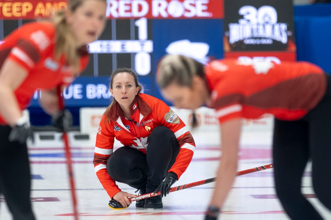 Rachel Homan watches a shot while her teammates sweep