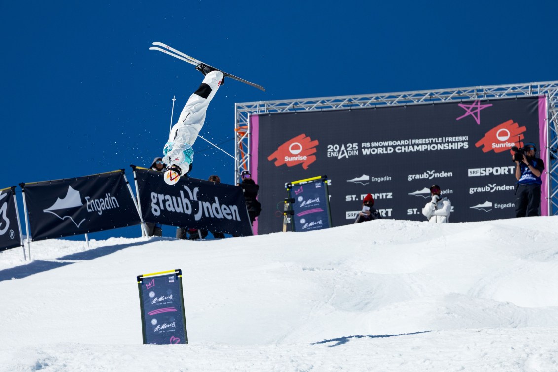 Mikael Kingsbury performs a flip on a moguls course in a lay out position