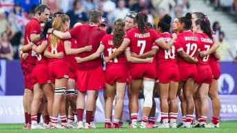 Team Canada women's rugby sevens players form a huddle