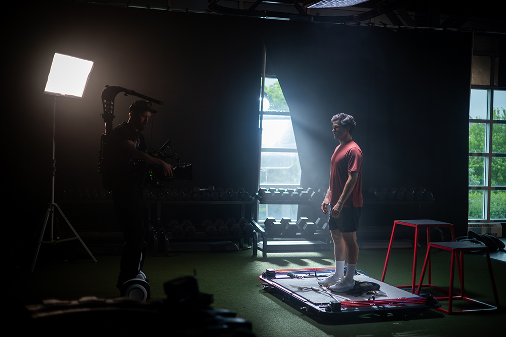 Mikaël Kingsbury staking on a platform wearing a red shirt and looking into a camera.