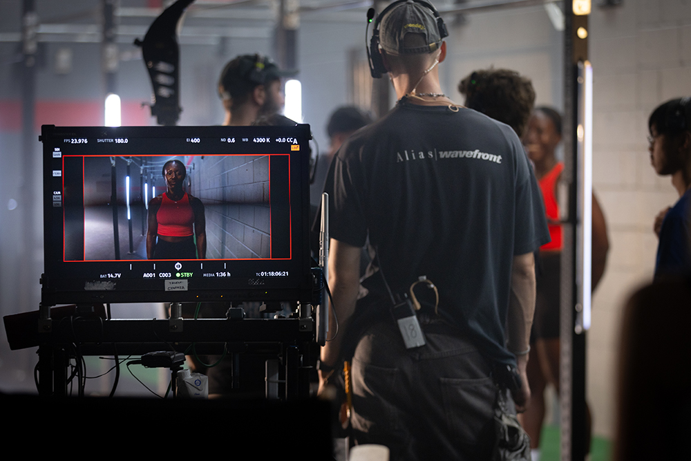 Cynthia Appiah wearing red seen through a screen.