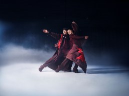 Piper Gilles and Paul Poirier dressed in burgundy pose on an ice rhink