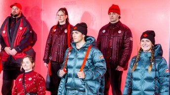 Six athletes pose in lululemon clothing, some in a green shade, some in a burgundy shade
