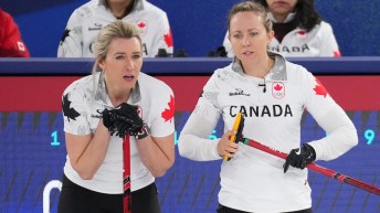 Emma Miskew and Rachel Homan discussing play during competition against Great Britain