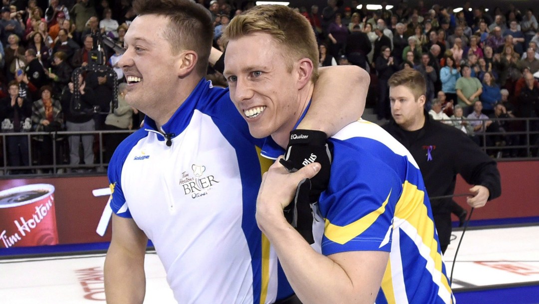Alberta lead Ben Hebert, left, celebrates with third Marc Kennedy