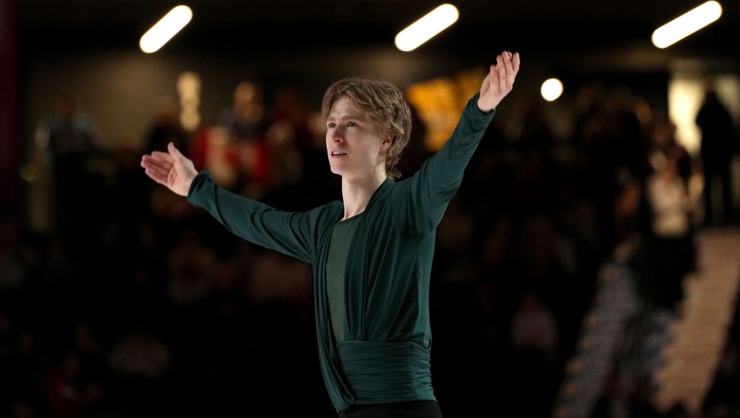 Stephen Gogolev skating to the medal ceremony