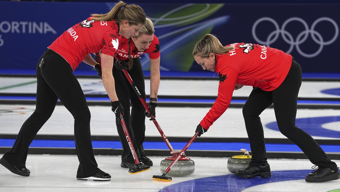 Canada's Rachel Homan, Sarah Wilkes and Emma Miskew in action during the women's curling round robin