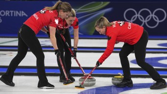 Canada's Rachel Homan, Sarah Wilkes and Emma Miskew in action during the women's curling round robin