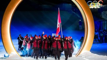 Canadian flag-bearers Mikaël Kingsbury and Marielle Thompson leading Team Canada