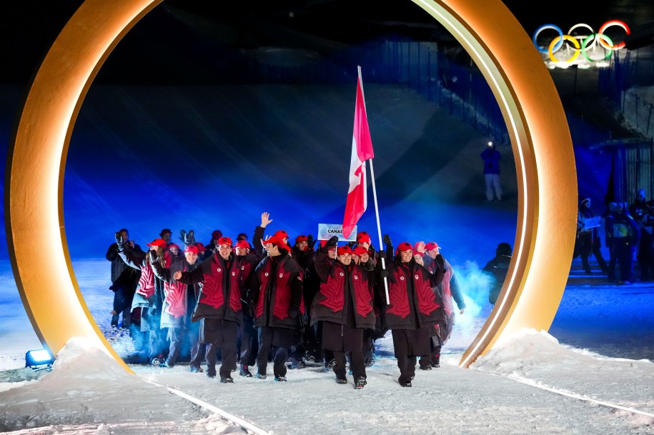 Canadian flag-bearers Mikaël Kingsbury and Marielle Thompson leading Team Canada