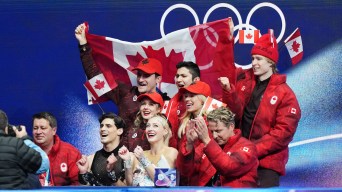 Members of Team Canada's figure skating team cheering