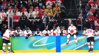 Team Canada'reacts near their bench following their loss to Team USA in the gold medal game of Women's Ice Hockey