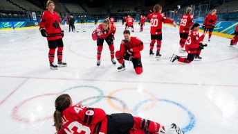 Members of Team Canada women's hockey pose for photos during a training session