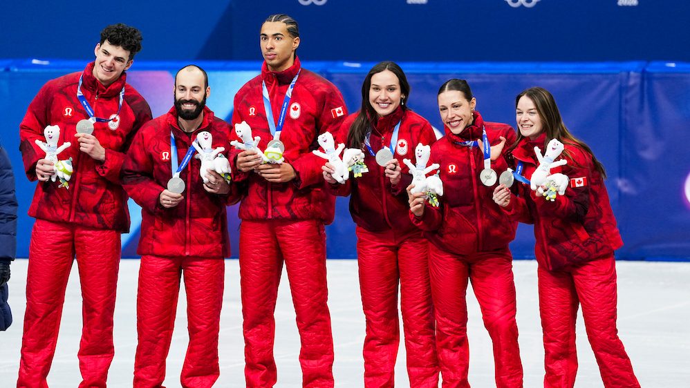Team Canada short track speed skaters Felix Roussel, Steven Dubois, William Dandjinou, Courtney Sarualt, Florence Brunelle and Kim Boutin celebrate on the podium