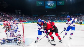 Team Canada's Natalie Spooner battles against United States' Kelly Pannek