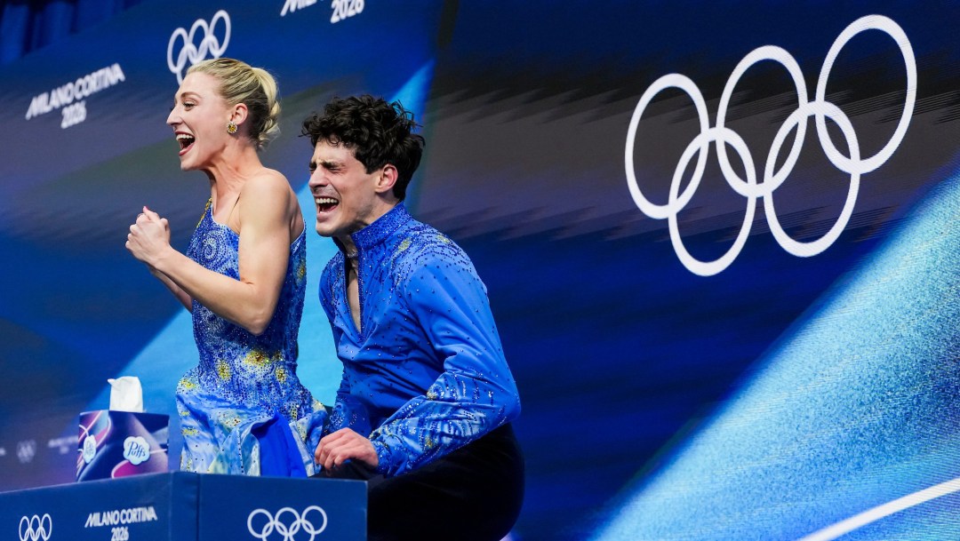 Team Canada’s Piper Gilles and Paul Poirier celebrate after competing in the Ice Dance