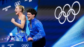 Team Canada’s Piper Gilles and Paul Poirier celebrate after competing in the Ice Dance