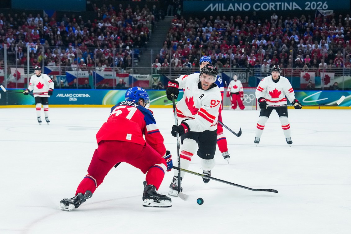 Connor McDavid shoots a puck against Radim Simek