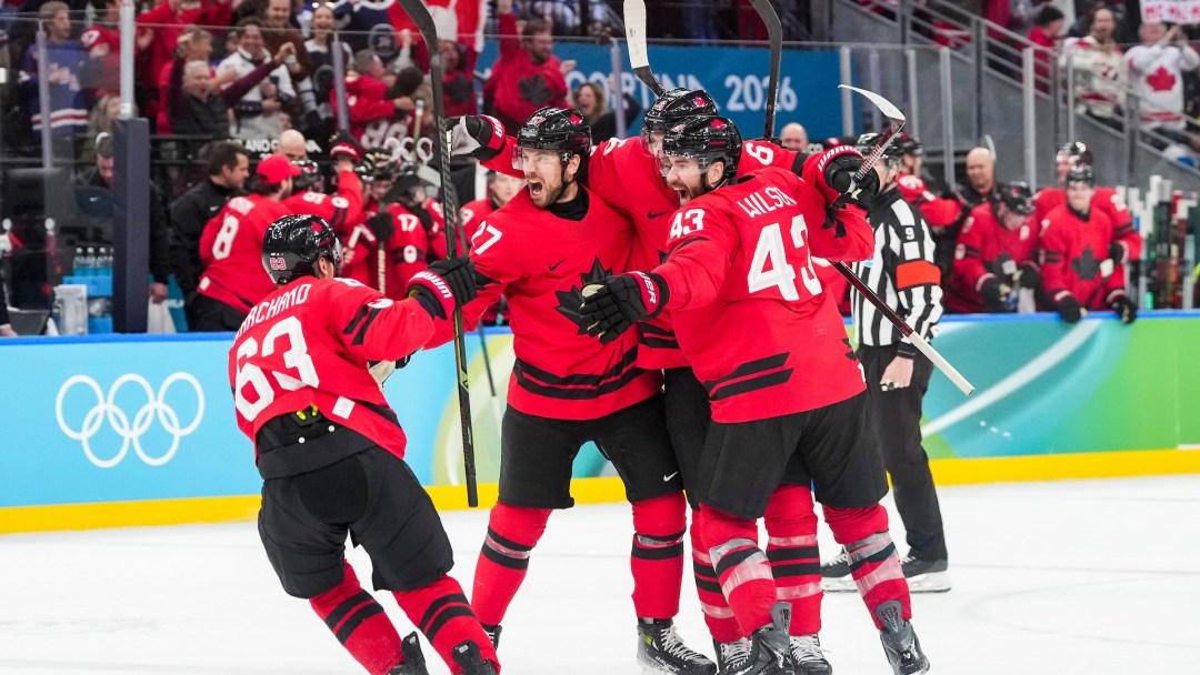 Shea Theodore celebrates scoring the game tying goal against Finland with teammates