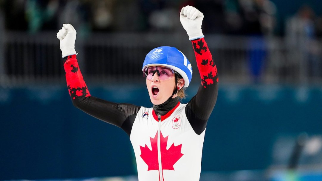 Ivanie Blondin raises her arms in celebration