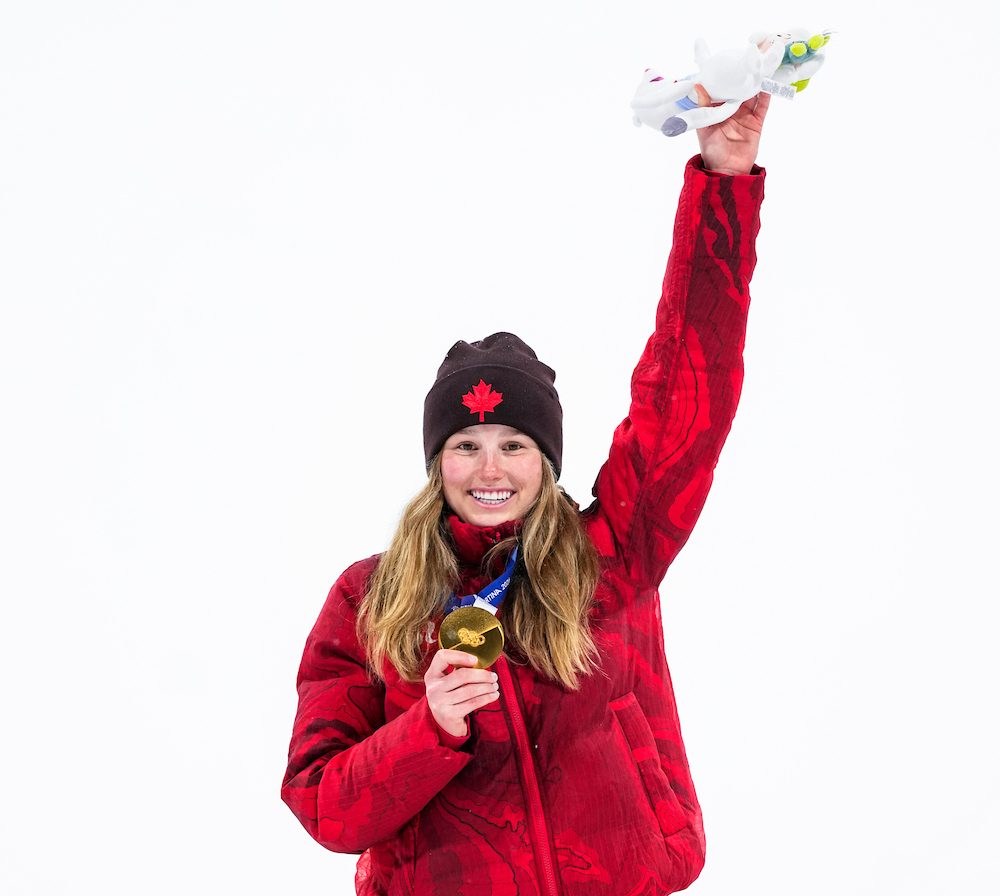 Megan Oldham of Team Canada holds her gold medal on the podium after winning the women's freeski big air event at the Milano Cortina 2026 Olympic Winter Games.