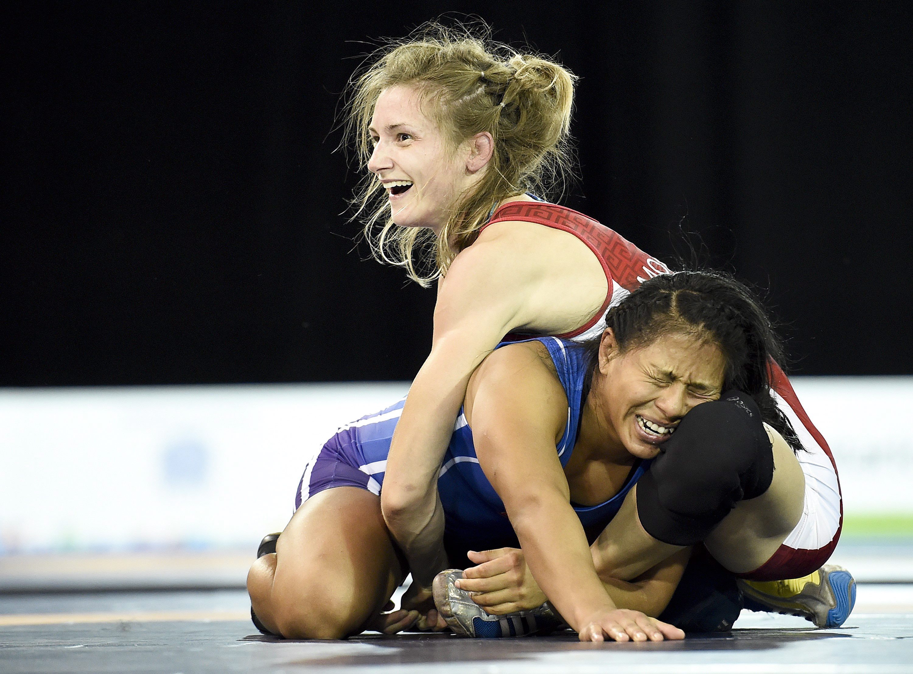 Gene Morrison, top, of Canada moments before time runs out to defeat Thalia Mallqui of Peru in the women's freestyle 48kg final during the Pan American Games in Toronto on Thursday, July 16, 2015. Morrison won gold. THE CANADIAN PRESS/Nathan Denette