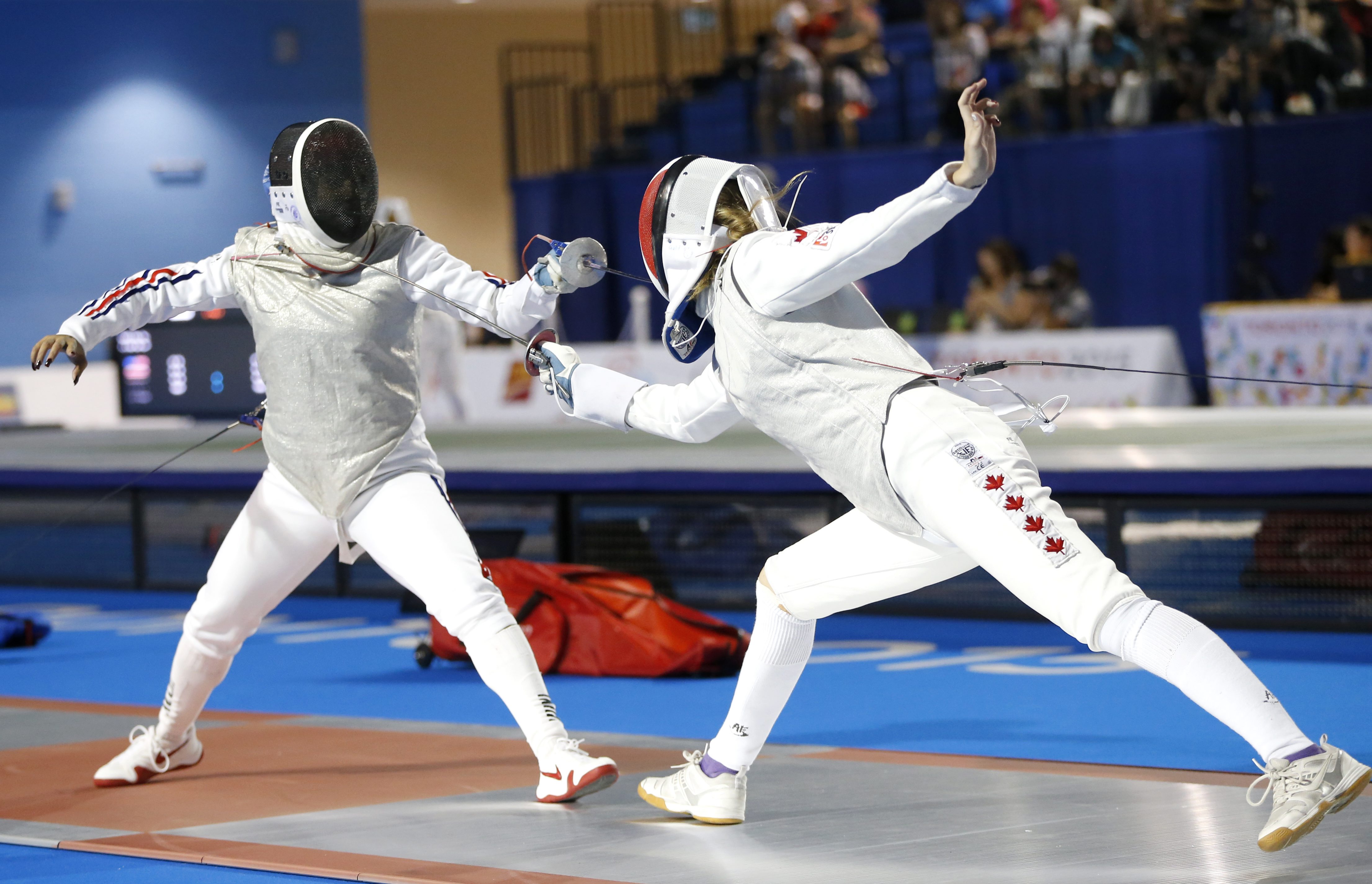 Cuba's Elizabeth Hidalgo, left, competes against Canada's Alanna Goldie during their women's foil individual quarterfinal match at the Pan Am Games, Wednesday, July 22, 2015, in Toronto. (AP Photo/Julio Cortez)
