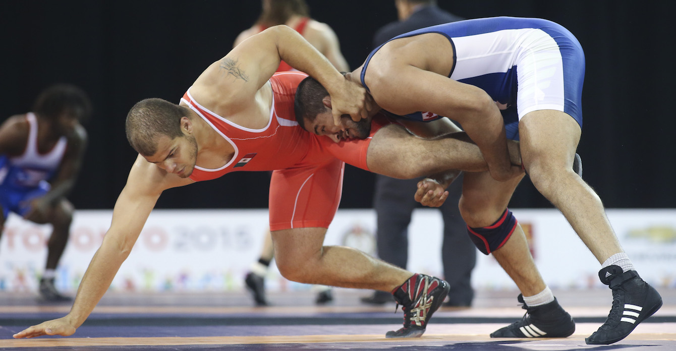 Arjun Gill (blue) of Surrey, B.C. defeated Jesse Ruiz of Mexico in the freestyle wrestling preliminaries at the PanAmerican Games in Mississauga, Ont., Saturday, July 18, 2015. Photo by Mike Ridewood/COC