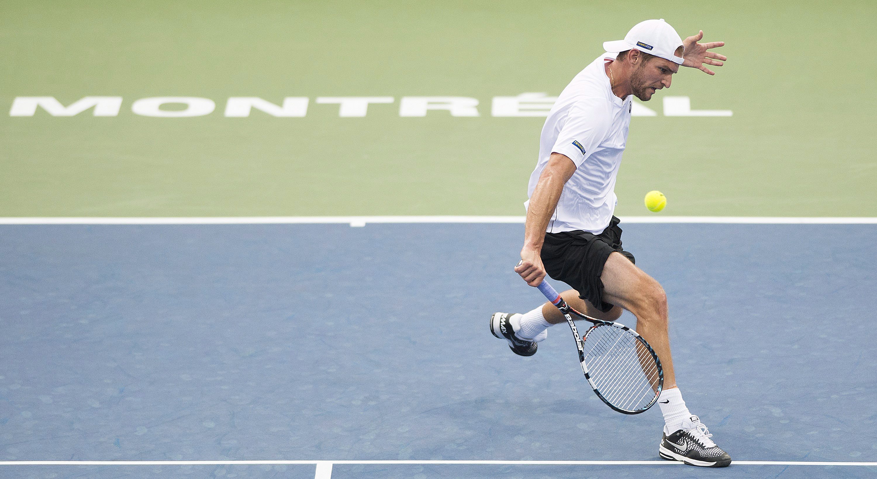 Philip Bester, of Canada, returns to Gilles Muller, from Luxemburg, during their first round match at the Rogers Cup tennis tournament in Montreal, on Monday, August 10, 2015. THE CANADIAN PRESS/Graham Hughes