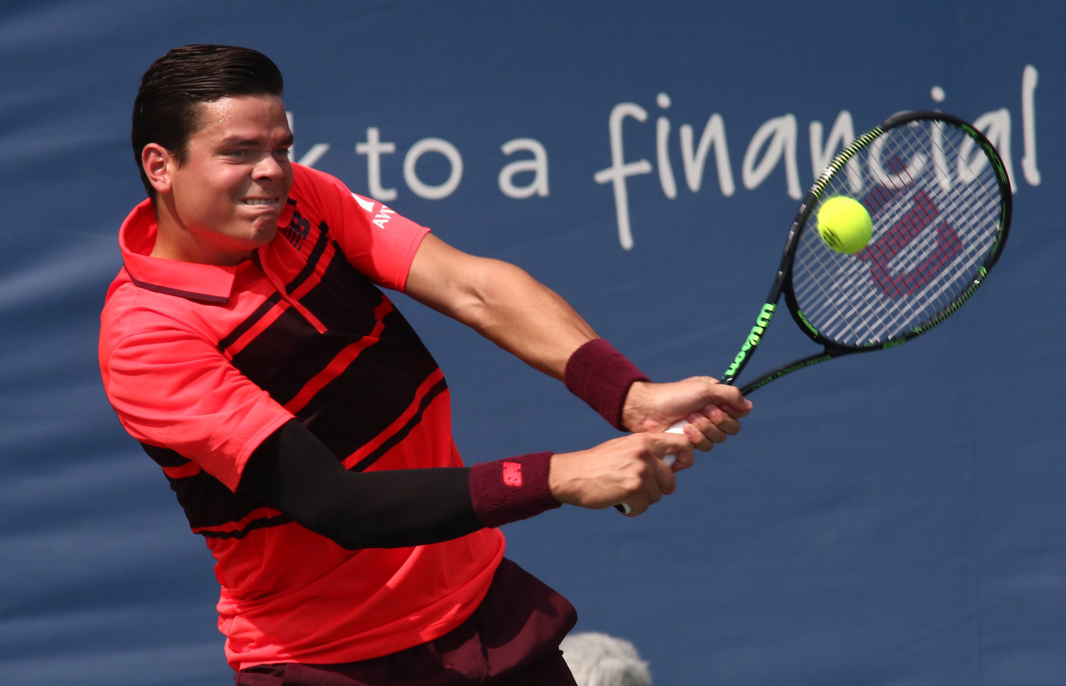 Milos Raonic, of Canada, returns the ball to Feliciano Lopez, of Spain, at the Western & Southern Open tennis tournament, Tuesday, Aug. 18, 2015, in Mason, Ohio. (AP Photo/Tom Uhlman)