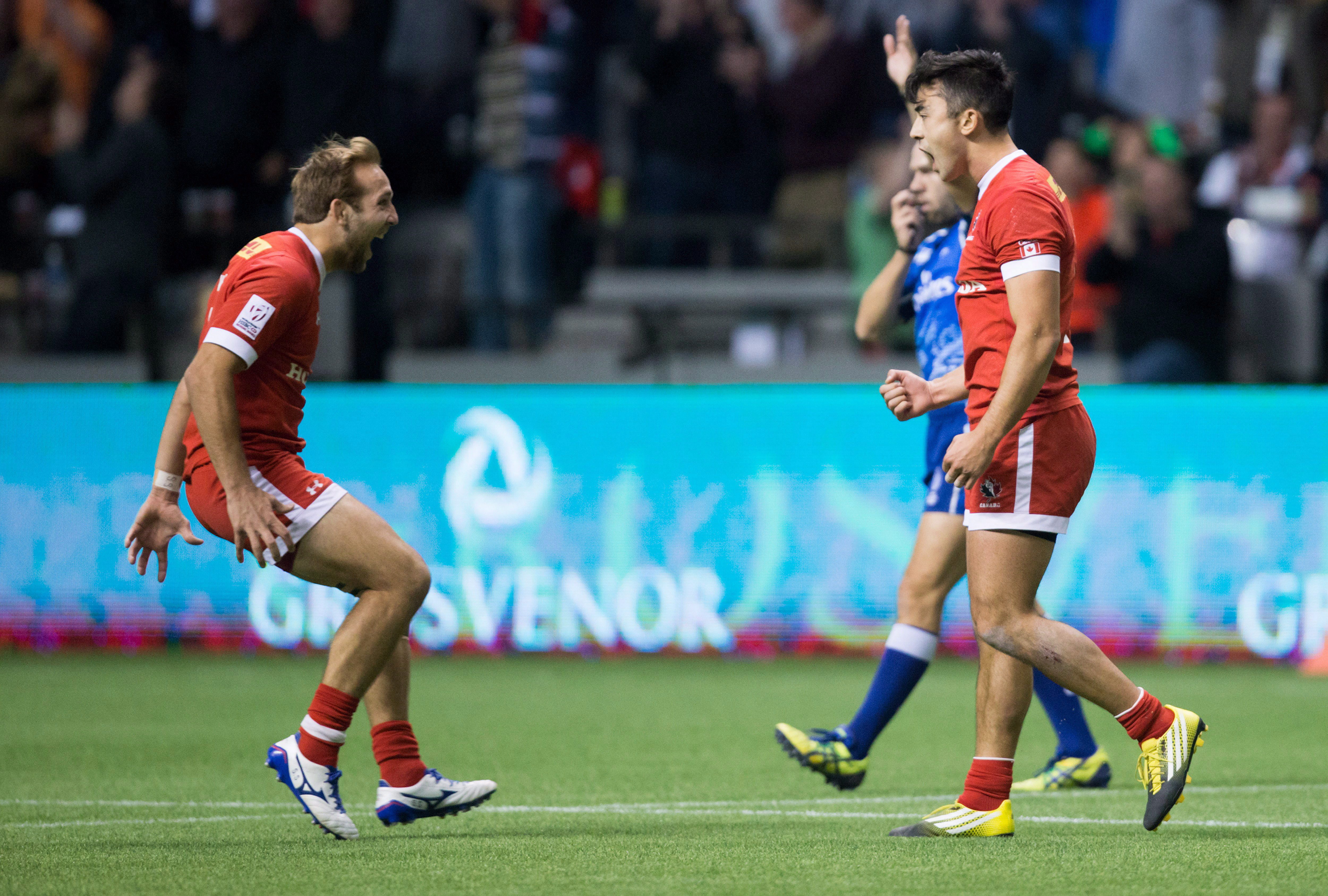 Canada's Sean White, left, and Nathan Hirayama celebrate after Hirayama kicked a conversion to defeat Australia during World Rugby Sevens Series' Canada Sevens tournament action, in Vancouver, B.C., on Saturday, March 12, 2016. THE CANADIAN PRESS/Darryl Dyck