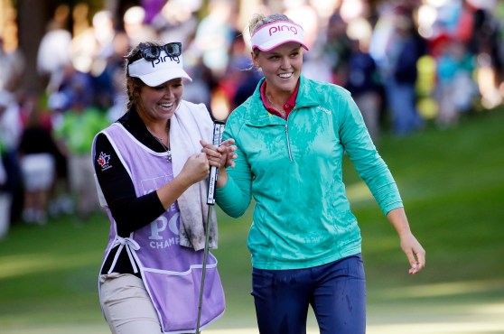 Brooke Henderson, of Canada, right, walks off the 18th green with her sister and caddy Brittany Henderson after winning the Women's PGA Championship golf tournament at Sahalee Country Club Sunday, June 12, 2016, in Sammamish, Wash. (AP Photo/Elaine Thompson)