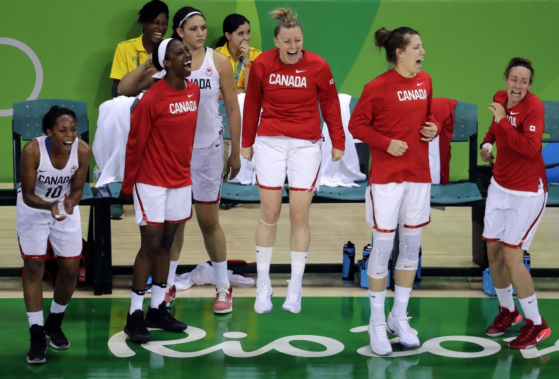 The Canadian bench celebrates after a teammate's basket during the second half of a women's basketball game against Serbia at the 2016 Summer Olympics in Rio de Janeiro, Brazil, Monday, Aug. 8, 2016. Canada won 71-67. (AP Photo/Charlie Riedel)