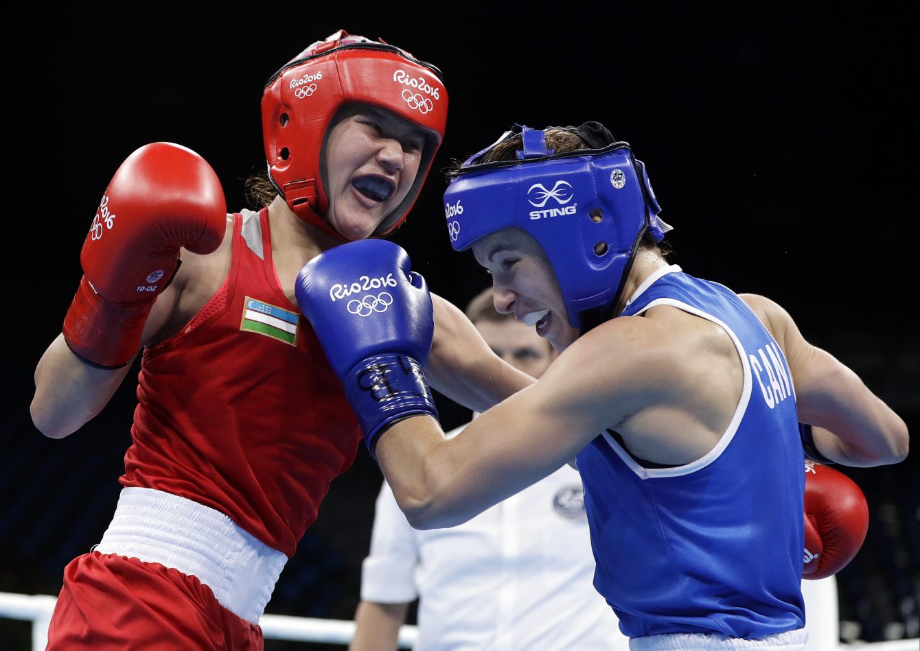 Mandy Bujold atteint son adversaire, Yodgoroy Mirzaeva au meton lors de son match de huitièmes de finale, le 12 août 2016 au Jeux olympiques de Rio. (AP Photo/Frank Franklin II)