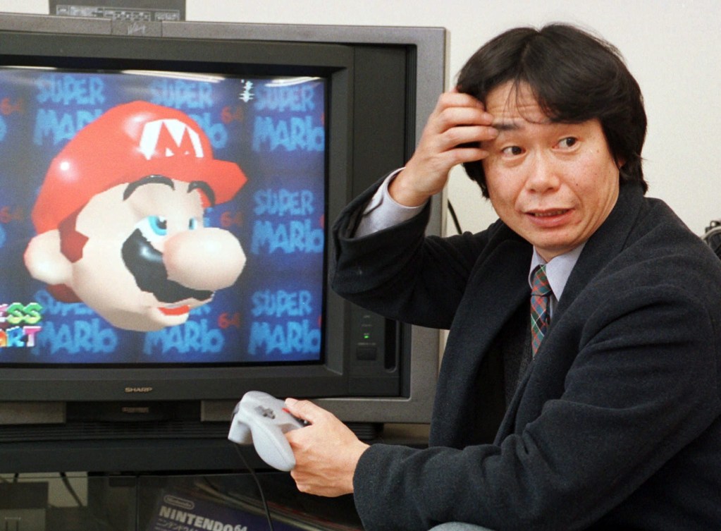 FILE - In this Feb. 6, 1997 file photo, Shigeru Miyamoto, creator of Super Mario video game series, demonstrates Super Mario 64 in his office at the Nintendo Co. headquarters in Kyoto, Japan. Even though Mario hasn't changed much in nearly three decades, the latest game he stars in, the newly released "The New Super Mario Bros. Wii," is one of the holiday season's top titles. (AP Photo/Atsushi Tsukada)
