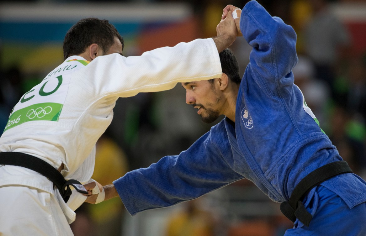Canada's Sergio Pessoa battle with Amiran Papinashvili of Georgia in the 60kg judo event at the Olympic games in Rio de Janeiro, Brazil, Saturday, August 6, 2016. Pessoa lost the match and did not advance. COC Photo by Jason Ransom