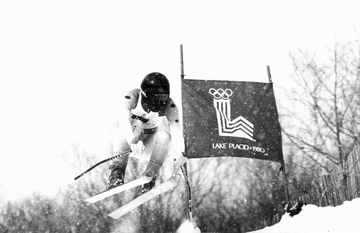 Le skieur Steve Podborski est dans les airs lors de la descente à Lake Placid, où son temps de 1:46,62 lui vaudra la médaille de bronze. (CP PHOTO/ AP)